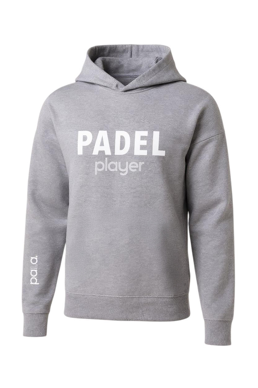 light gray hoodie with a minimalist design. It has the words "PADEL player" printed in white across the chest — “PADEL” in bold uppercase letters, and “player” in a lighter, lowercase font underneath. On the left sleeve near the wrist, the brand name "pala." is printed vertically in white. The hoodie features a classic design with a front pocket (not visible in the image but implied), ribbed cuffs, and a ribbed hem.