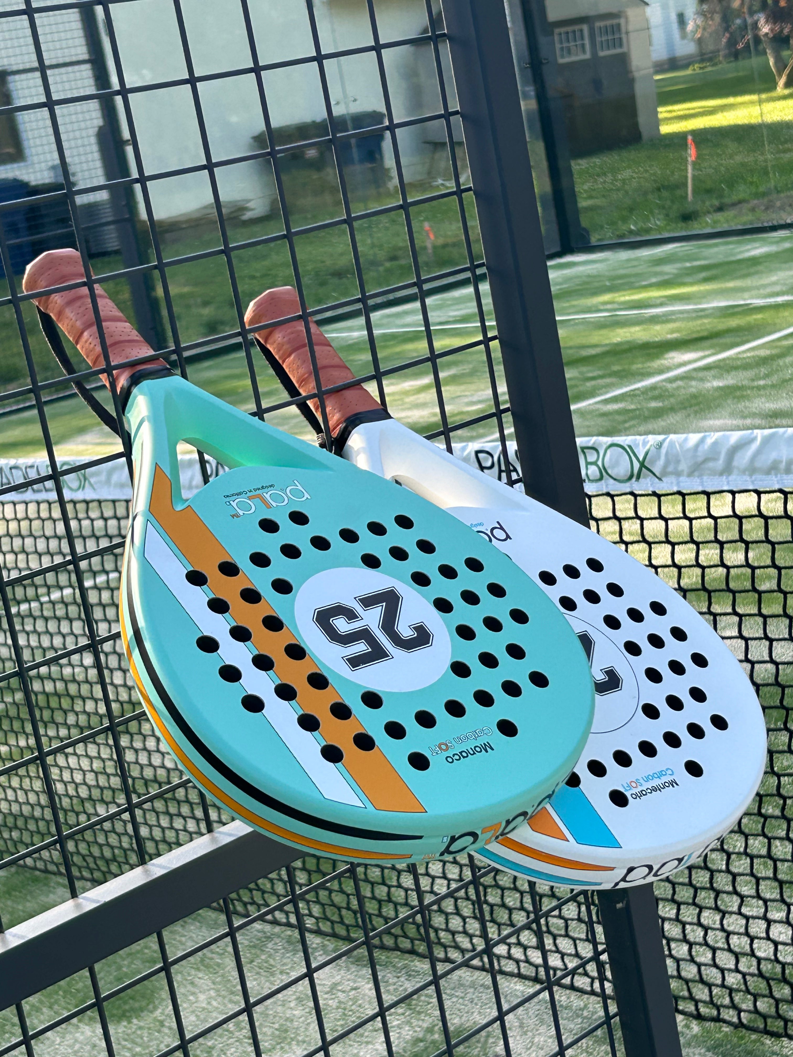 Close-up of PALA Monaco and Montecarlo padel rackets, featuring ergonomic grips and high-quality construction