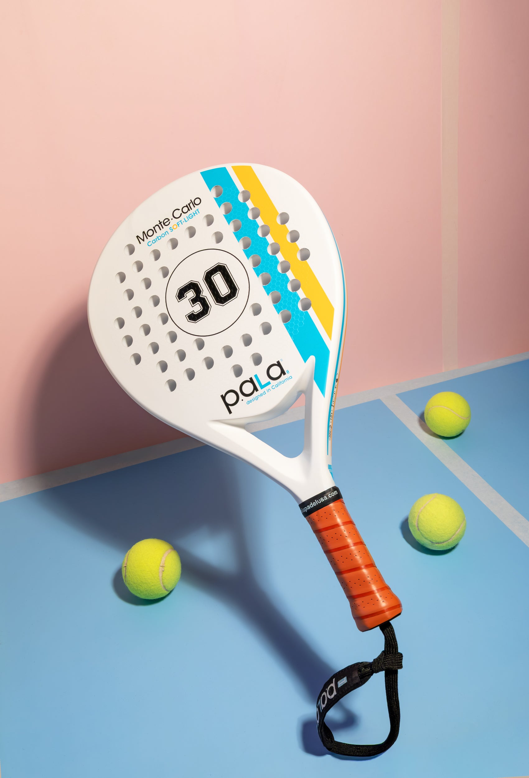 pala padel racket on a blue and pink background with 3 padel balls