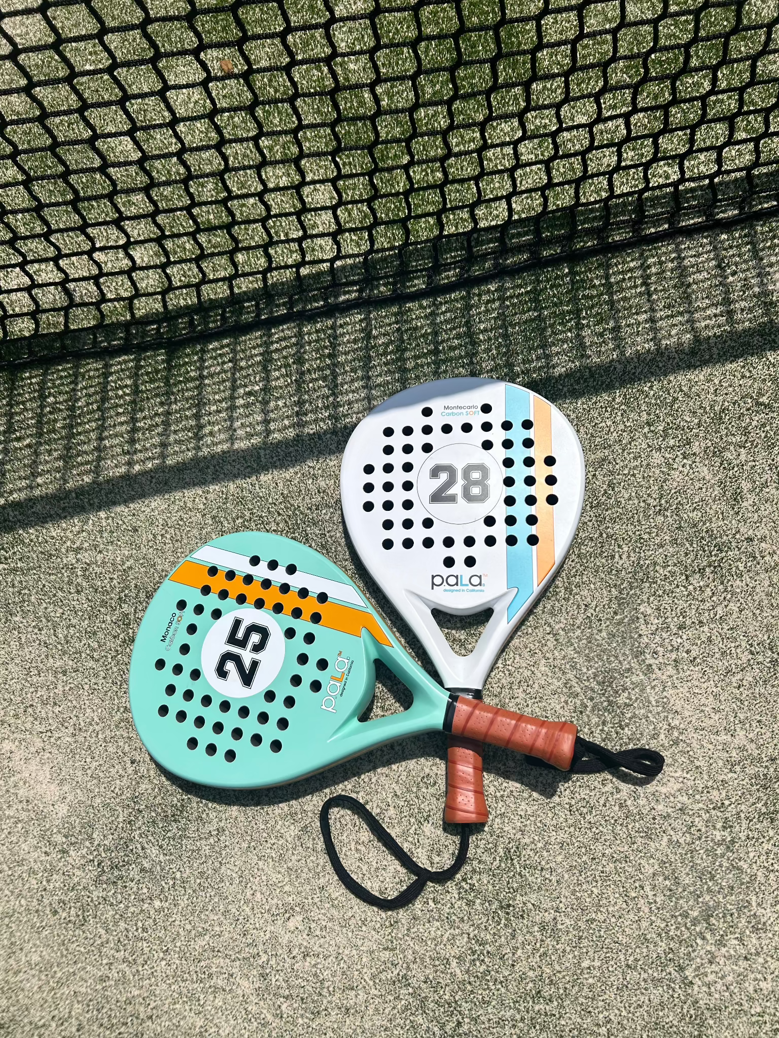 Colorful PALA padel rackets with leather-like grips, perfect for enhancing your game on the court