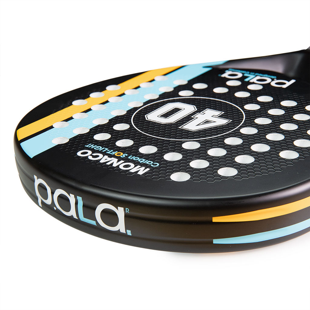Close-up of a Pala padel racket with branding on a white background