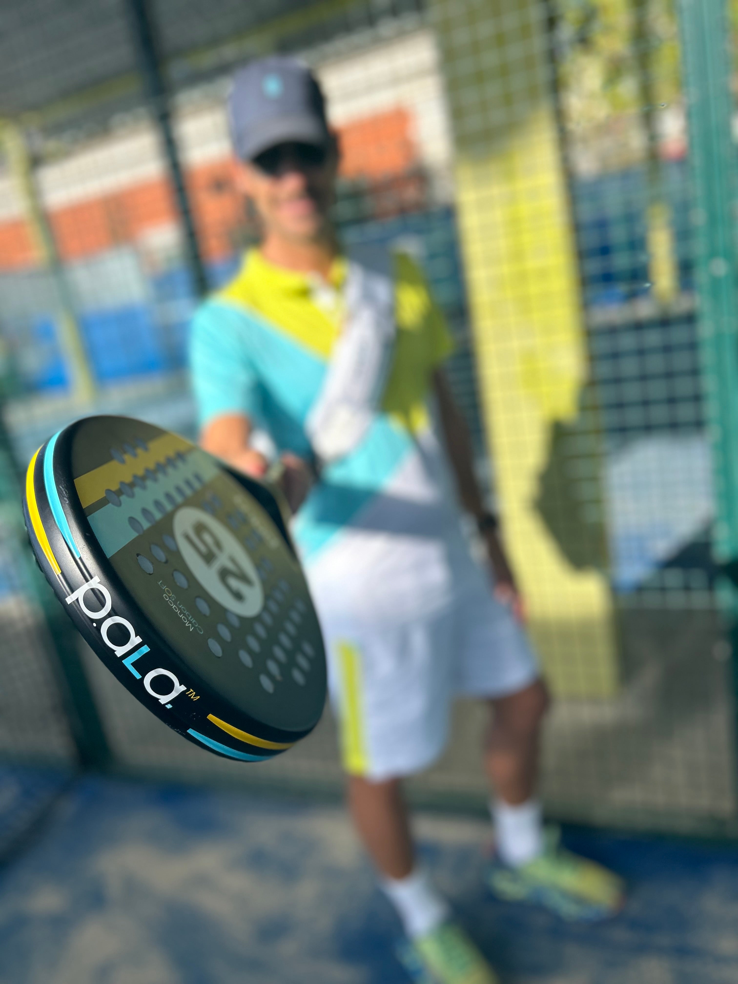 men playing padel in a padel court with p.ala padel racket monaco black