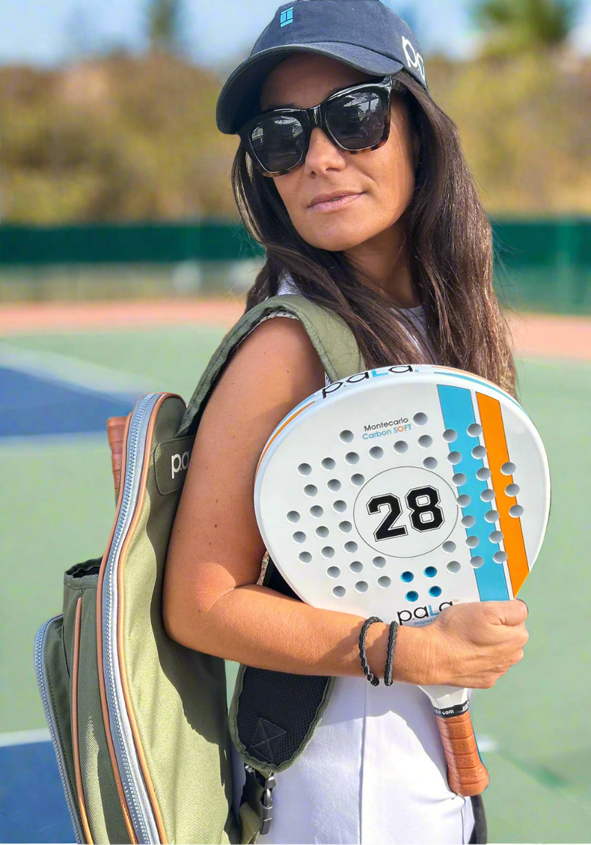 women with padel racket and green padel bag by p.ala designed in california playing padel
