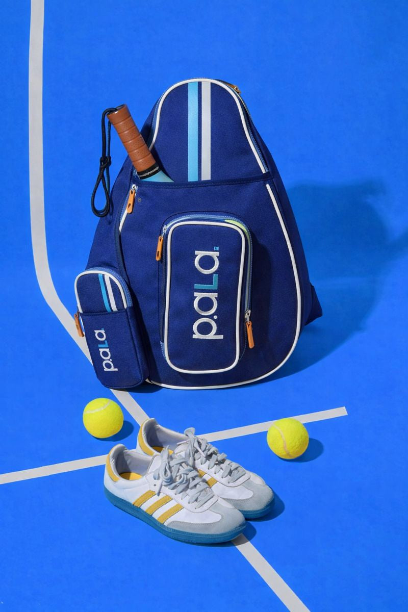 pala padel bag blue  for padel tennis and pickleball in a padel court with padel balls