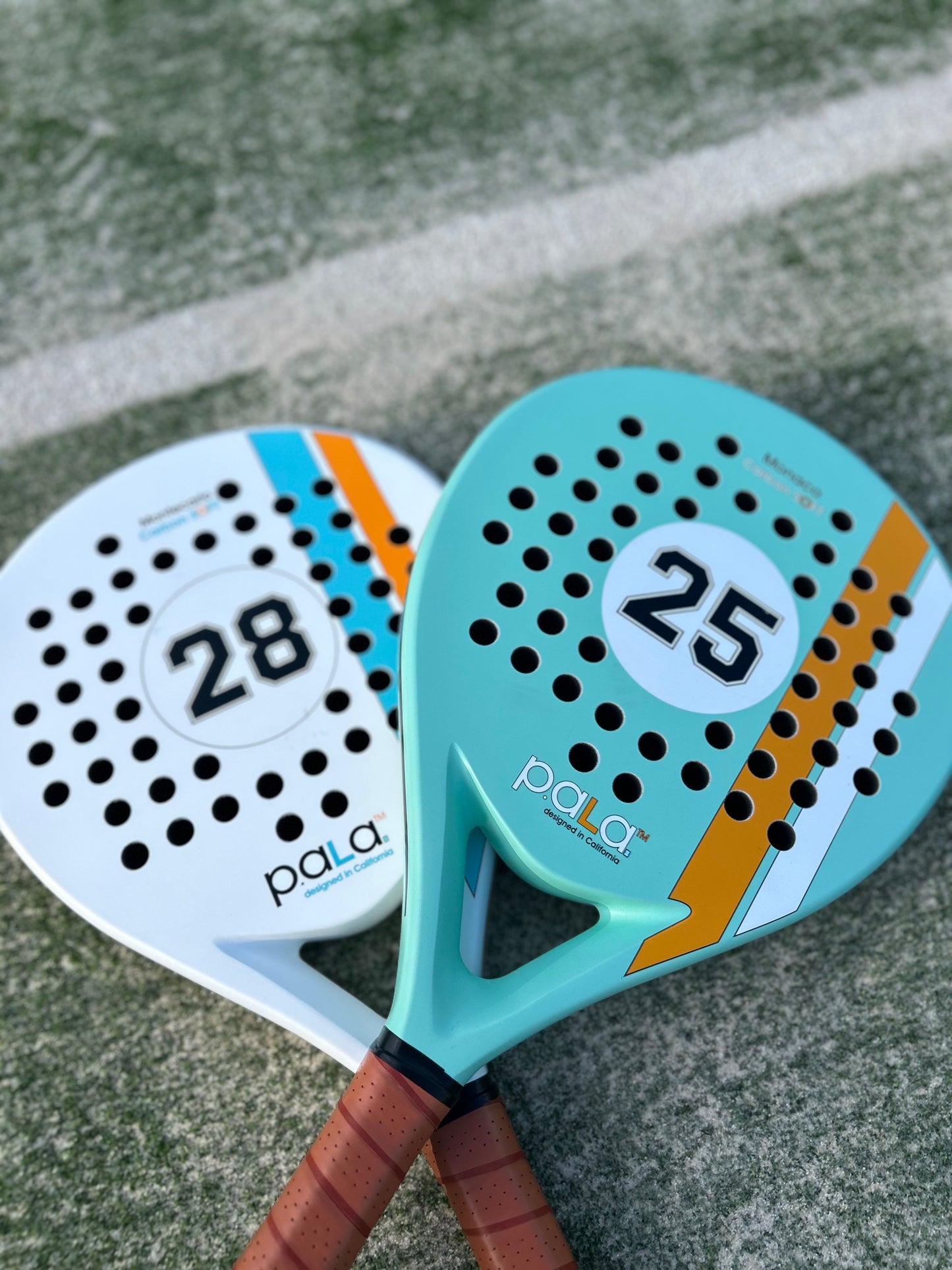 Colorful PALA padel rackets with leather-like grips, perfect for enhancing your game on the court