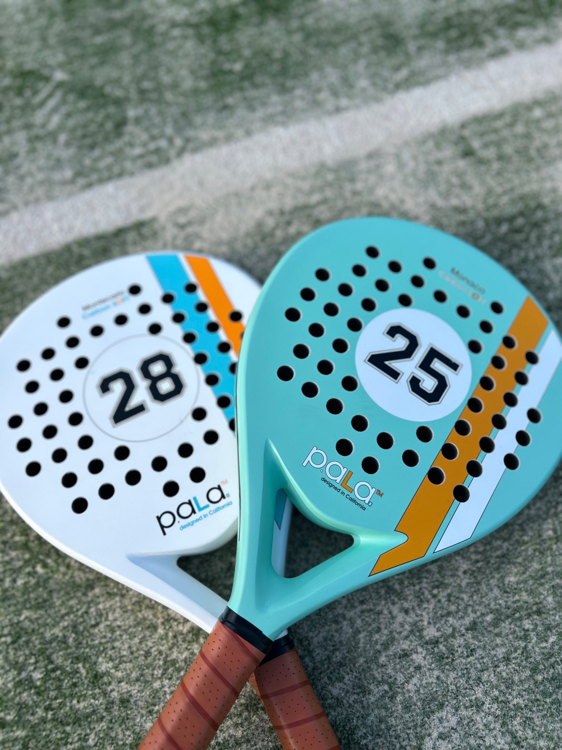 Colorful PALA padel rackets with leather-like grips, perfect for enhancing your game on the court