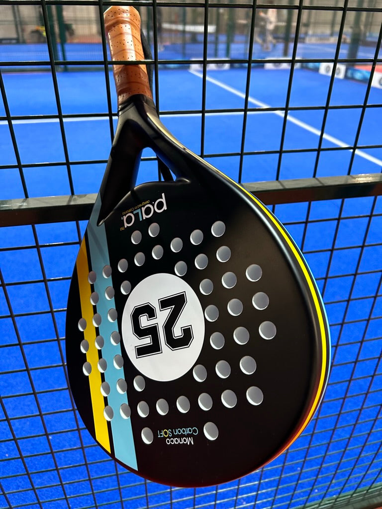 PALA PADEL RACKET HANGING ON FENCE ON A PADEL COURT IN USA